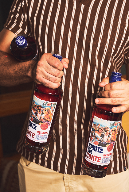 A person holding two bottles of Spritz Del Conte Negroni