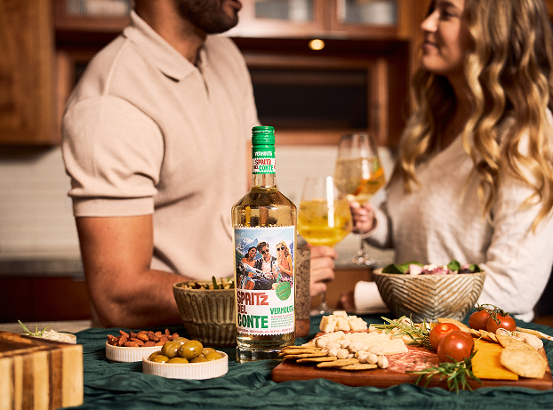 A couple enjoying Spritz Del Conte Vermouth with a charcuterie board